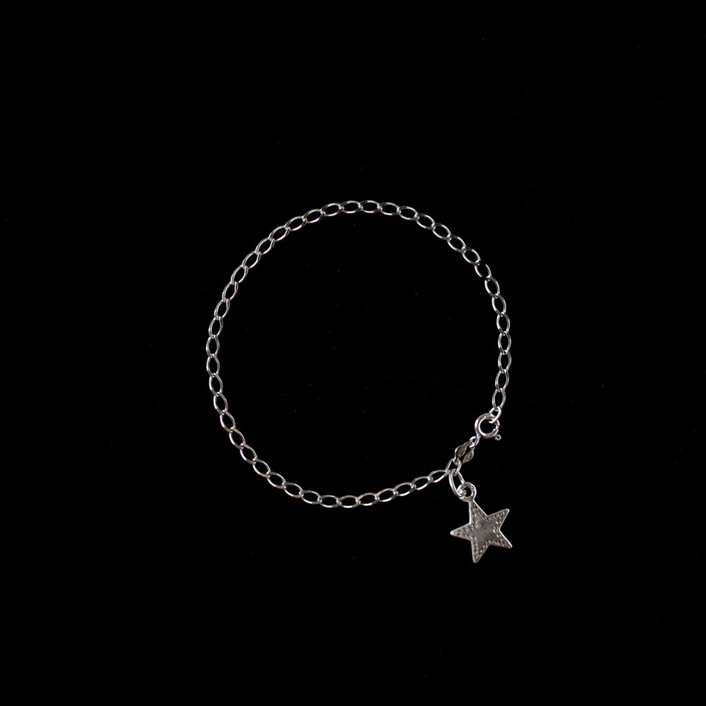 Sterling Silver star charm on a sterling silver bracelet